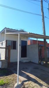 a small white house with a garage at Olivia in Paysandú
