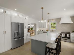 a kitchen with white cabinets and a white counter top at Cambridge Beaches Resort and Spa in Somerset