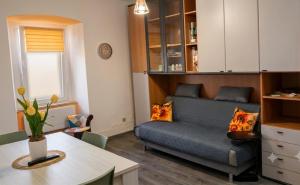 a living room with a bed and a table at La Casetta al Poggio in Valentano