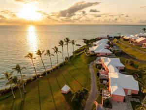 an aerial view of a resort near the ocean with palm trees at Cambridge Beaches Resort and Spa in Somerset
