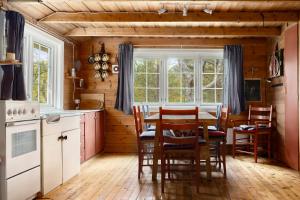 a kitchen with a table and chairs in a room at Åstin in Dirdal