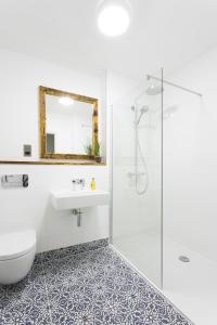 a bathroom with a shower and a toilet and a sink at Owen House Farm in Knutsford