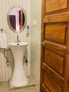 a bathroom with a sink and a mirror on the wall at The lake house in Bhīm Tāl