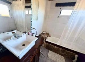 a bathroom with a sink and a bath tub at Dorrego Apart 3 in Guaymallen