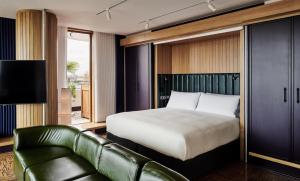 a hotel room with a bed and a couch at The Standard London in London
