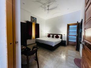 a bedroom with a bed and a table and a chair at The lake house in Bhīm Tāl +20 photos
