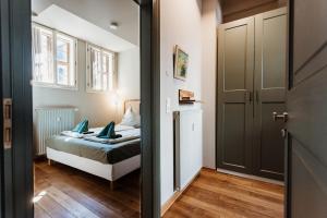 a bedroom with a bed with blue pillows at Boutique Apartment QLB est 1688 in Quedlinburg