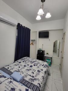 a bedroom with a bed and a blue curtain at Paseo Miami in Miami