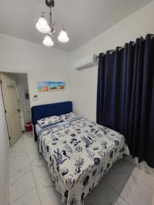 a bedroom with a bed and a blue curtain at Paseo Miami in Miami