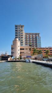 a body of water with buildings in the background at PREMIUM Puerto Varadero Apartamento con Vista al Mar y Planta Total in Tucacas