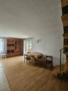 a living room with a wooden table and chairs at Dom w Zbychowie in Gniewowo
