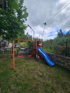 a playground with a slide in a yard at Dom w Zbychowie in Gniewowo