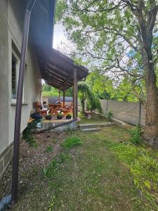 a backyard with a wooden pergola on a house at Dom w Zbychowie in Gniewowo