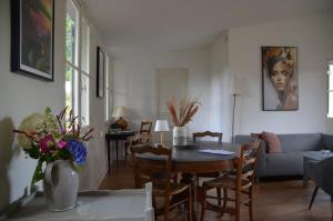 a living room with a table and chairs at Chateau de Salorges - Field gite I in Corancy