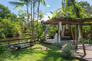 a woman in a white dress standing in a gazebo at Odoyá Casa Hotel in Paraty