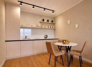 a kitchen and dining room with a table and chairs at Ауельбекова 120 in Kokshetau