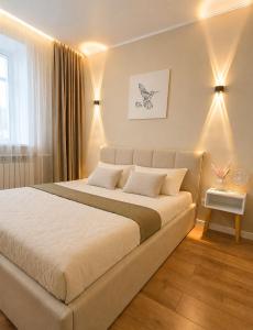a bedroom with a large bed in a room at Ауельбекова 120 in Kokshetau