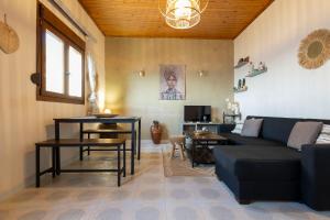 a living room with a couch and a table at Ambelos, Lesvos Beach House in Koustáros