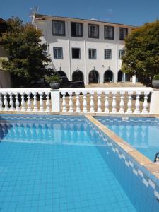 a swimming pool in front of a building at Hotel Solar de Maria in Ouro Preto