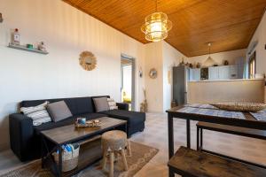 a living room with a couch and a table at Ambelos, Lesvos Beach House in Koustáros