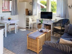 a living room with a couch and a table at 4 star holiday home in onsala in Onsala +27 photos