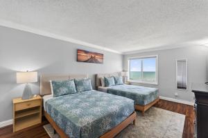a bedroom with two beds and a window at Oceanfront Beach Condo, Pool, Gym, Fishing Surfing in Virginia Beach +28 photos