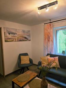 a living room with a couch and a table at Rosa in Rydułtowy