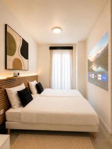 a bedroom with a large bed and a couch at Hotel de la gare in Pantin +9 photos