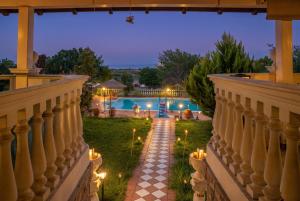 a view from the balcony of a villa with a pool at Pietra Mare Suites Villa in Palaión Eleftherochórion