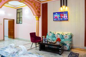 a living room with a couch and a table at Residency Trilok in Varanasi