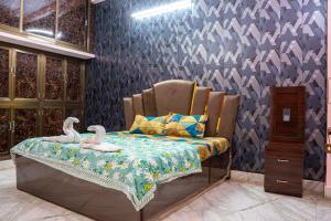 a bedroom with a bed with two swans on it at Residency Trilok in Varanasi +58 photos