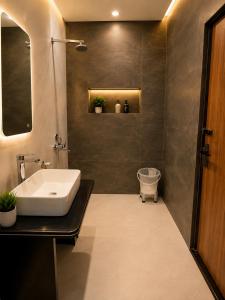 a bathroom with a sink and a toilet in it at Hotel Aaradhya Residency in Agra