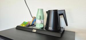 a coffee maker sitting on top of a table at Penzion Restaurace Ostrov in Písek