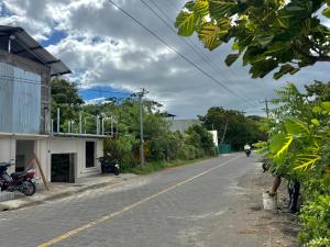 an empty road with a person riding a motorcycle down the street at Casa Hostal Samaria in Altagracia