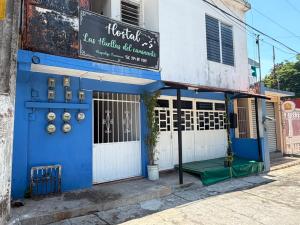 a blue building with a sign on the side of it at Las Huellas del Caminante in Catemaco