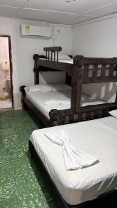 two bunk beds in a room with a green carpet at Hotel Casa Molina in Coveñitas