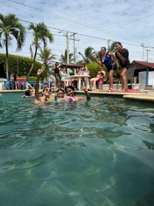 a group of people in a swimming pool at Hotel Casa Molina in Coveñitas +9 photos
