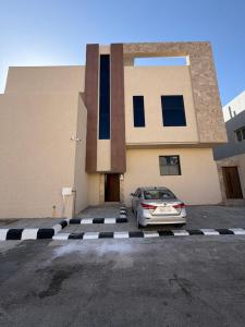 a car parked in a parking lot in front of a building at SORANO Apartments in Hail