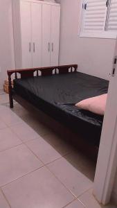 a bed in a room with a black mattress at Casa Aconchegante S8km do parque do peão in Barretos +1 photo