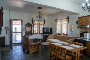 a living room with a couch and a table at Pietra Mare Suites Villa in Palaión Eleftherochórion