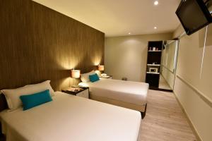 Giường trong phòng chung tại Mariel Hotel Boutique