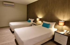 Giường trong phòng chung tại Mariel Hotel Boutique
