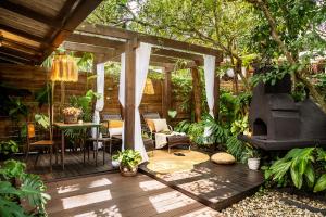 a patio with a fireplace and a table and chairs at Chalés Magia do Campeche in Florianópolis