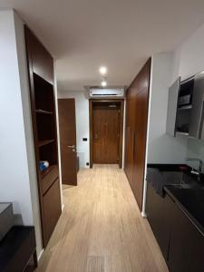 a hallway leading to a room with a wooden door at SeaBreeze White Villa 42 in Nardaran