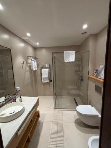 a bathroom with a shower and a sink and a toilet at SeaBreeze White Villa 42 in Nardaran