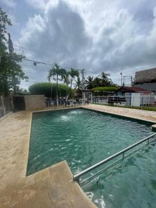 a large swimming pool with blue green water at Hotel Casa Molina in Coveñitas