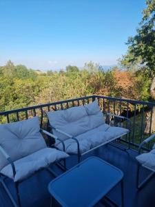 a balcony with couches and tables on a railing at Villa Leos in Ferizaj +9 photos