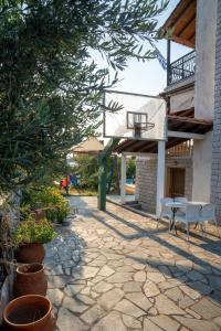 a patio with a table and a basketball hoop at Pietra Mare Suites Villa in Palaión Eleftherochórion