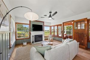 a living room with a couch and a fireplace at Cedar Nest - Lakefront Cabin Retreat in Madill