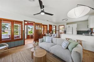a living room with a couch and a kitchen at Cedar Nest - Lakefront Cabin Retreat in Madill